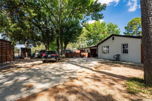 9305 Emnora Ln, Houston, TX 77080 - view of home's exterior with a gate, driveway, and brick siding