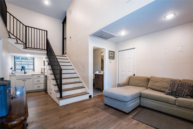 9305 Emnora Ln, Houston, TX 77080 - living area featuring stairs, dark wood-style flooring, and recessed lighting