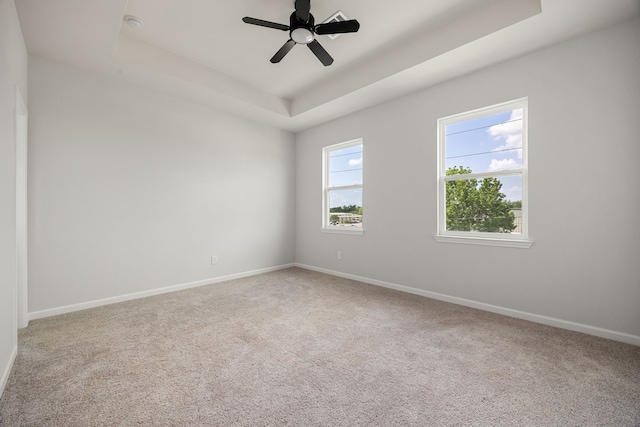 8 Donna Ct, Brookshire, TX 77423 - empty room with a tray ceiling, carpet, baseboards, and ceiling fan