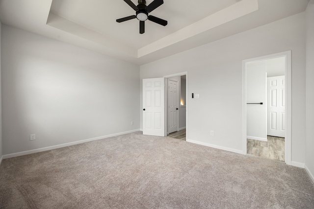 8 Donna Ct, Brookshire, TX 77423 - unfurnished bedroom with a raised ceiling, carpet flooring, baseboards, and ceiling fan