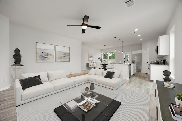 8 Donna Ct, Brookshire, TX 77423 - living room with light wood-style floors, a ceiling fan, recessed lighting, and baseboards