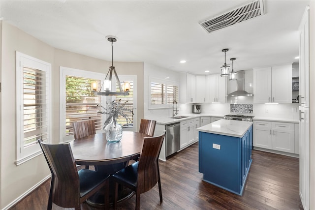 6923 Cobblestone Path, Houston, TX 77084 - kitchen featuring wall chimney exhaust hood, a sink, stainless steel dishwasher, white cabinetry, and plenty of natural light