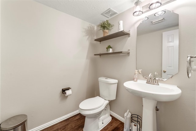 6923 Cobblestone Path, Houston, TX 77084 - half bath featuring wood finished floors, toilet, and baseboards