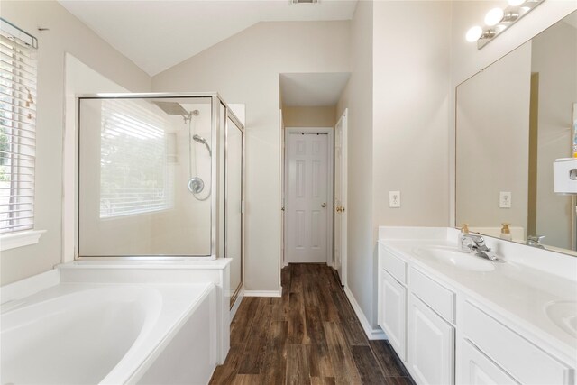 6923 Cobblestone Path, Houston, TX 77084 - bathroom featuring a stall shower, a bath, double vanity, wood finished floors, and lofted ceiling