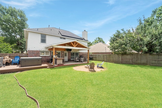 6923 Cobblestone Path, Houston, TX 77084 - rear view of house featuring a hot tub, a wooden deck, brick siding, a patio, and an outdoor fire pit