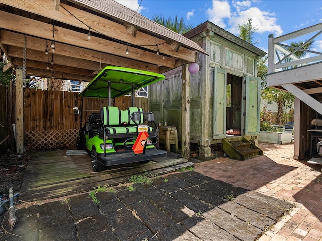 1014 20th St, Galveston, TX 77550 - wooden deck with an outdoor structure and a patio