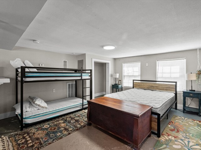 1014 20th St, Galveston, TX 77550 - bedroom featuring finished concrete floors, baseboards, and a textured ceiling