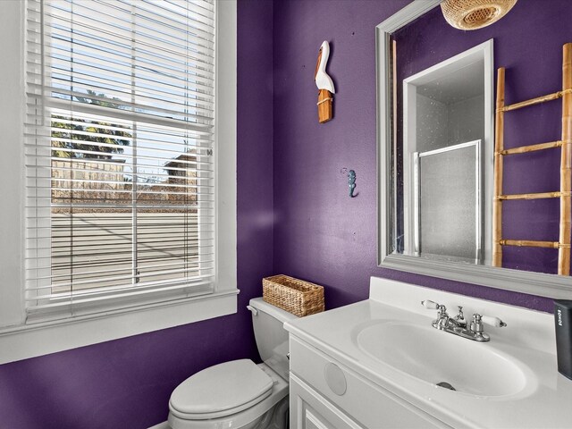 1014 20th St, Galveston, TX 77550 - bathroom featuring plenty of natural light, toilet, vanity, a textured wall, and a shower with shower door
