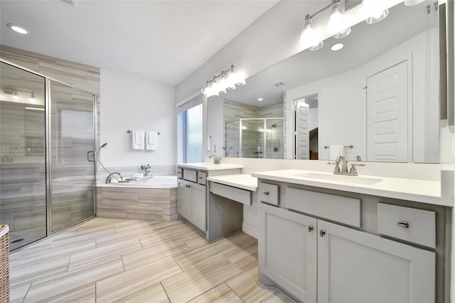 28172 Woodland Bend Way, Spring, TX 77386 - full bath featuring two vanities, a shower stall, a bath, and recessed lighting