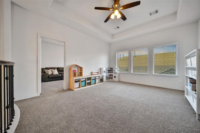 28172 Woodland Bend Way, Spring, TX 77386 - recreation room featuring a tray ceiling, carpet, ceiling fan, and baseboards