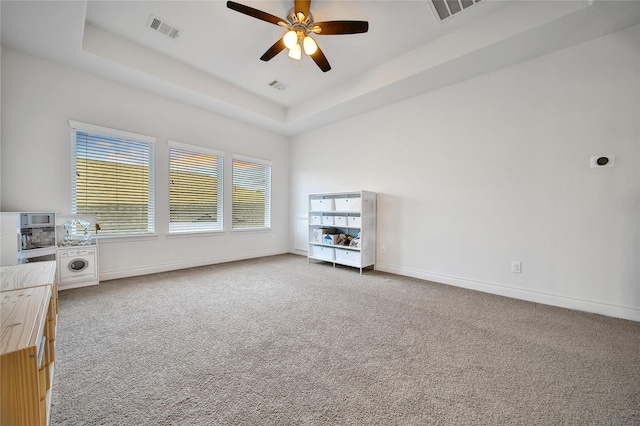 28172 Woodland Bend Way, Spring, TX 77386 - empty room with carpet flooring, a ceiling fan, baseboards, and a tray ceiling