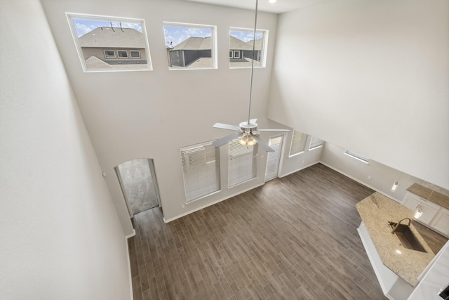 18318 Windy Knoll Way, Houston, TX 77084 - unfurnished living room with plenty of natural light, wood finished floors, arched walkways, and ceiling fan