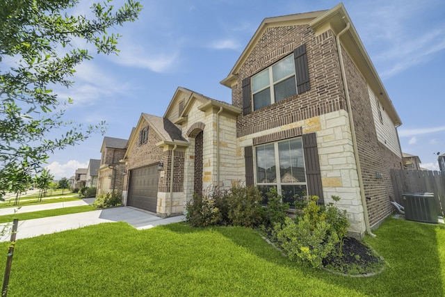 18318 Windy Knoll Way, Houston, TX 77084 - view of front of property featuring stone siding, brick siding, concrete driveway, and central AC