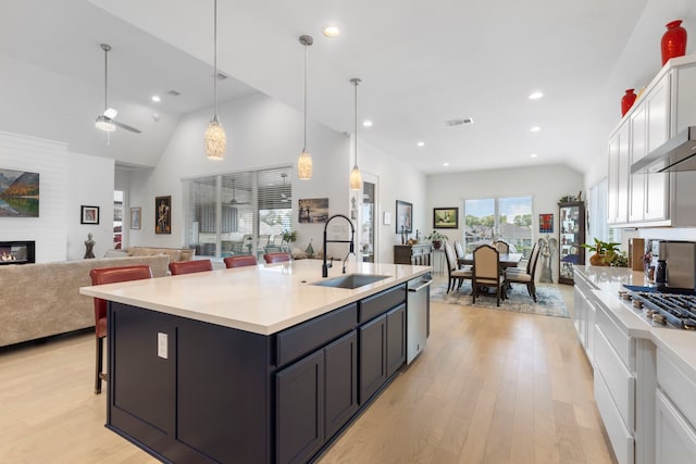 12211 Grey Plover Ct, Conroe, TX 77304 - kitchen featuring white cabinets, light wood-style flooring, appliances with stainless steel finishes, light countertops, and ceiling fan