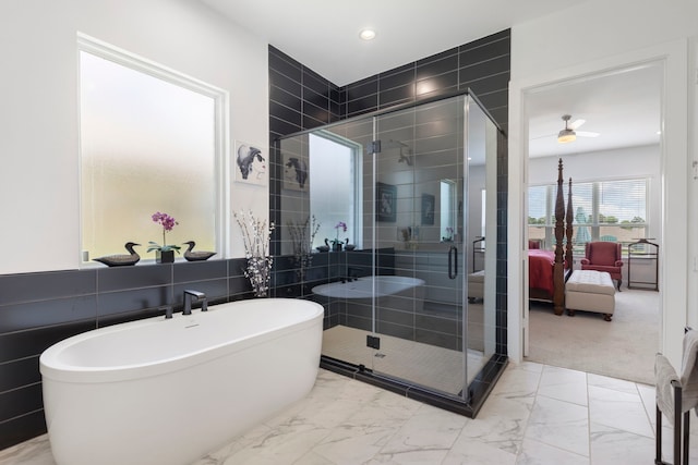 12211 Grey Plover Ct, Conroe, TX 77304 - full bathroom with marble finish flooring, ensuite bath, a freestanding bath, a stall shower, and recessed lighting