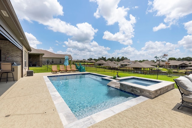 12211 Grey Plover Ct, Conroe, TX 77304 - view of swimming pool with a patio area, a pool with connected hot tub, and a residential view