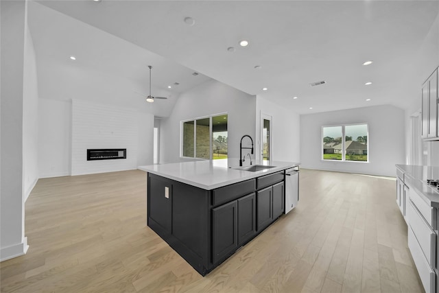 12211 Grey Plover Ct, Conroe, TX 77304 - kitchen featuring open floor plan, ceiling fan, light wood-style flooring, stainless steel dishwasher, and light countertops