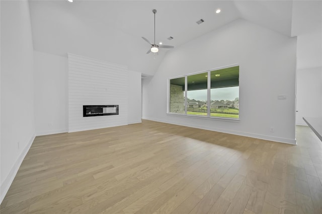 12211 Grey Plover Ct, Conroe, TX 77304 - unfurnished living room with ceiling fan, a fireplace, light wood-type flooring, high vaulted ceiling, and recessed lighting