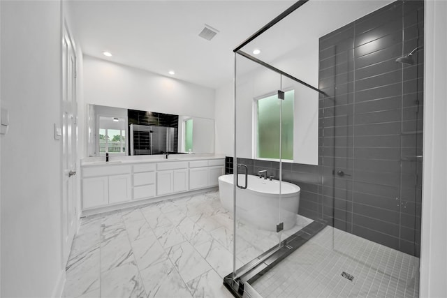 12211 Grey Plover Ct, Conroe, TX 77304 - full bath with marble finish flooring, a freestanding bath, a shower stall, double vanity, and recessed lighting