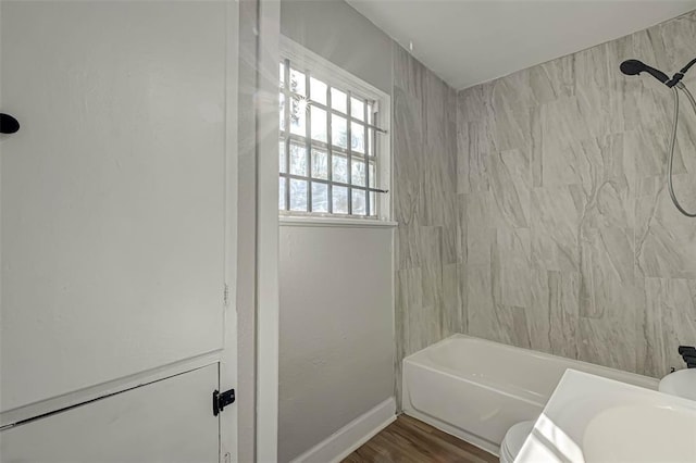 5102 Lyndhurst Dr, Houston, TX 77033 - bathroom with toilet, tub / shower combination, wood finished floors, and baseboards