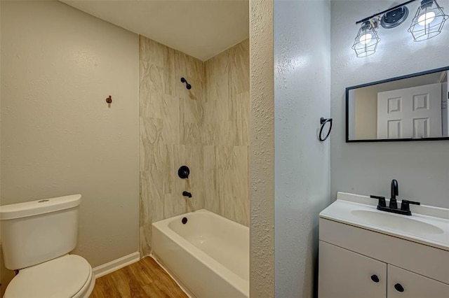 5102 Lyndhurst Dr, Houston, TX 77033 - bathroom with wood finished floors, toilet, vanity, tub / shower combination, and baseboards