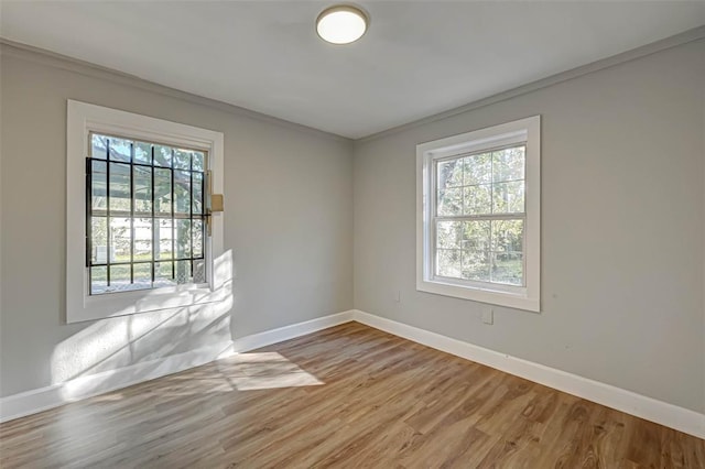 5102 Lyndhurst Dr, Houston, TX 77033 - unfurnished room with baseboards, light wood-style floors, healthy amount of natural light, and ornamental molding