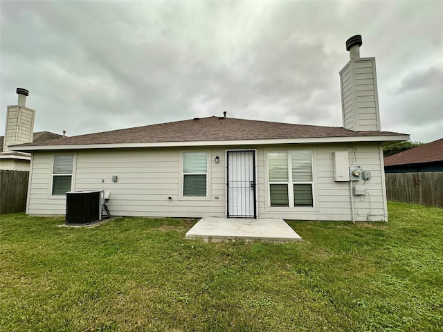 5642 Park Village Dr, Houston, TX 77048 - rear view of house with central air condition unit, a chimney, and a patio