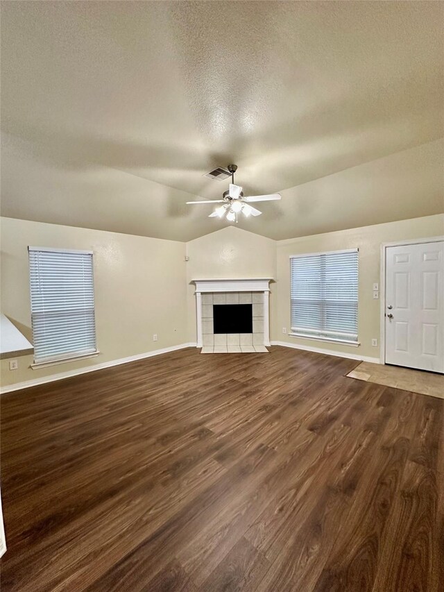 5642 Park Village Dr, Houston, TX 77048 - unfurnished living room with a ceiling fan, baseboards, a textured ceiling, dark wood-type flooring, and lofted ceiling