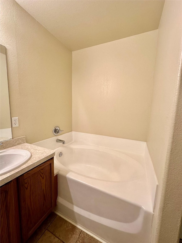 5642 Park Village Dr, Houston, TX 77048 - bathroom with vanity, a garden tub, tile patterned flooring, and a textured wall