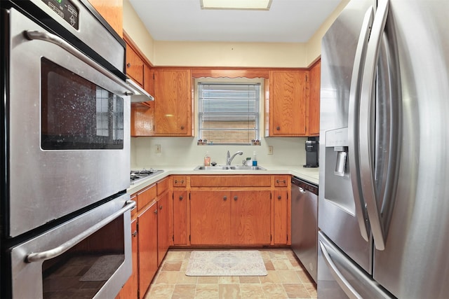 16203 White Star Dr, Houston, TX 77062 - kitchen with appliances with stainless steel finishes, a sink, light countertops, and brown cabinets