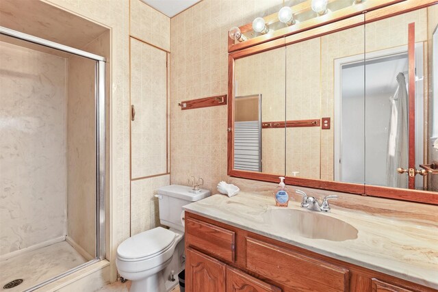 16203 White Star Dr, Houston, TX 77062 - bathroom featuring vanity, a stall shower, toilet, and tile walls