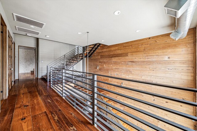 808 Coronado St, Houston, TX 77009 - corridor featuring wooden walls, an upstairs landing, hardwood / wood-style flooring, and recessed lighting