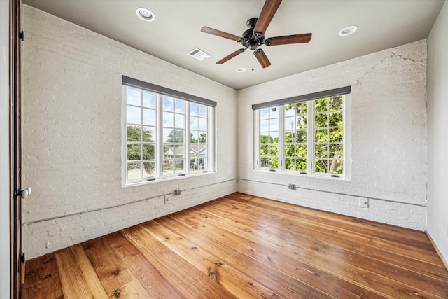 808 Coronado St, Houston, TX 77009 - empty room featuring brick wall, a ceiling fan, wood finished floors, and recessed lighting