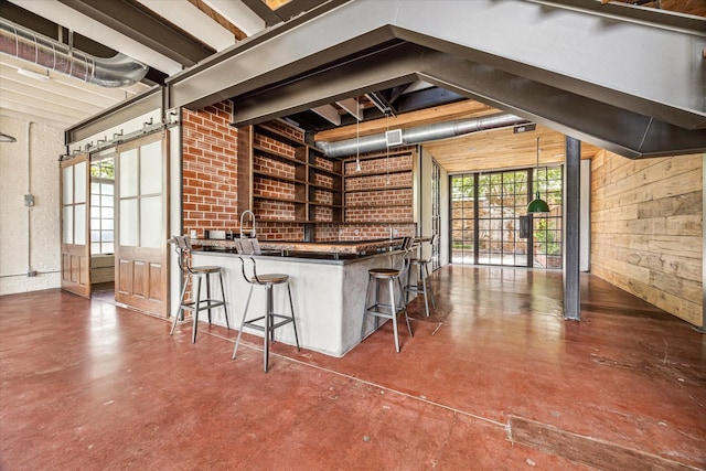 808 Coronado St, Houston, TX 77009 - kitchen featuring concrete flooring, dark countertops, wood walls, a breakfast bar, and open shelves