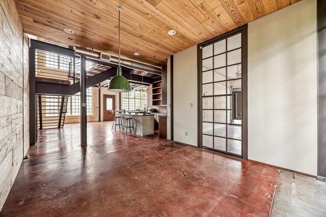 808 Coronado St, Houston, TX 77009 - unfurnished dining area with wooden ceiling, concrete floors, and recessed lighting