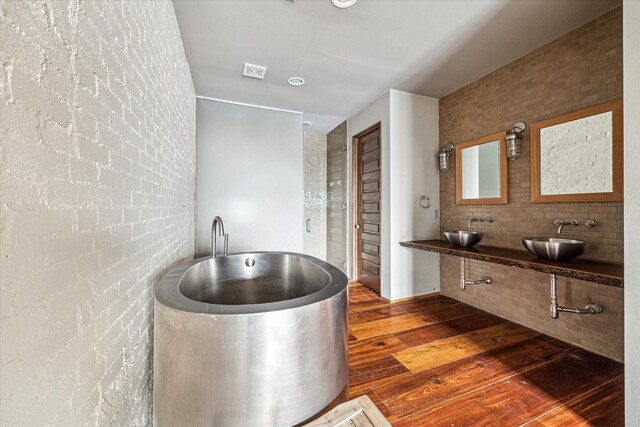 808 Coronado St, Houston, TX 77009 - full bathroom featuring a sink, wood finished floors, and a freestanding bath
