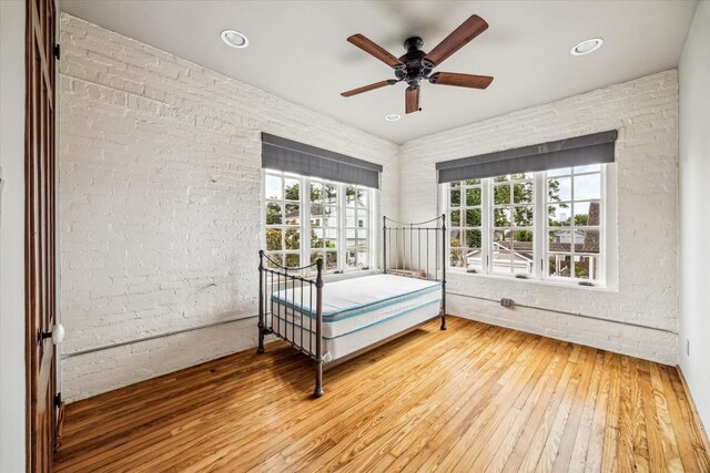 808 Coronado St, Houston, TX 77009 - bedroom with hardwood / wood-style floors, multiple windows, brick wall, recessed lighting, and ceiling fan