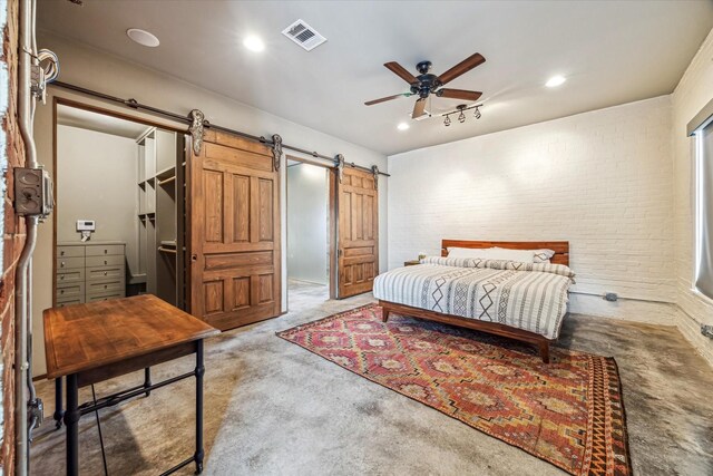 808 Coronado St, Houston, TX 77009 - bedroom featuring a barn door, carpet flooring, brick wall, a ceiling fan, and recessed lighting