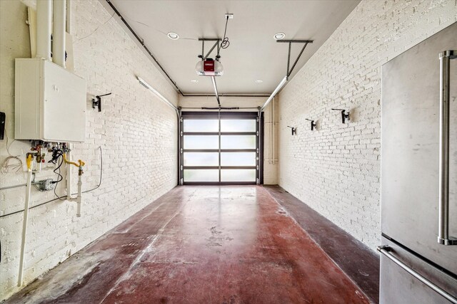 808 Coronado St, Houston, TX 77009 - garage featuring a garage door opener and freestanding refrigerator