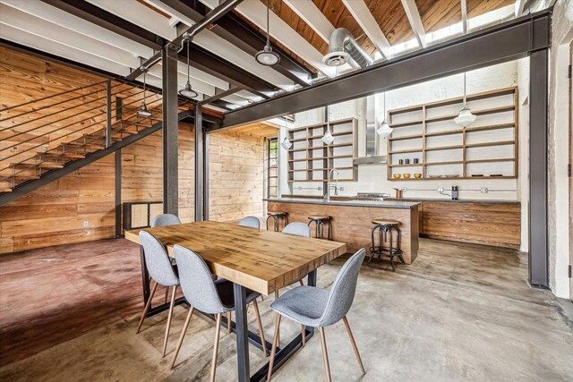 808 Coronado St, Houston, TX 77009 - dining space with concrete flooring, wood walls, and wet bar