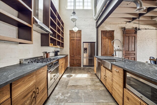 808 Coronado St, Houston, TX 77009 - kitchen featuring appliances with stainless steel finishes, a sink, open shelves, a towering ceiling, and brown cabinets