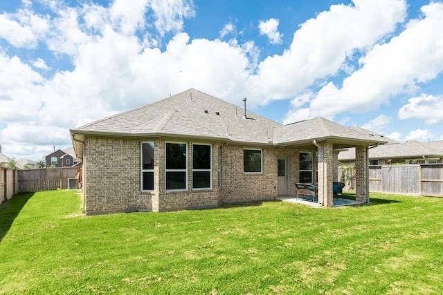 203 Bentwater Ln, Clute, TX 77531 - rear view of house featuring a patio area, brick siding, and a shingled roof
