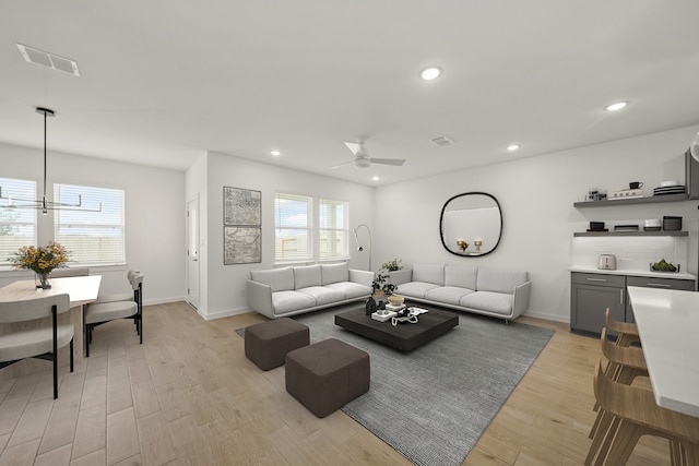 8335 Bay Oaks Dr, Baytown, TX 77523 - living area featuring light wood finished floors, a ceiling fan, baseboards, and recessed lighting