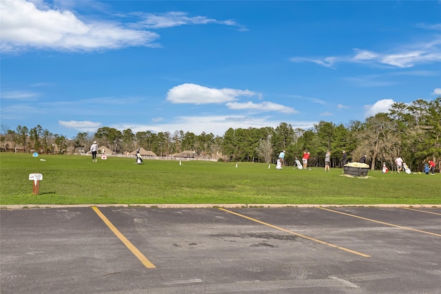 1511 Tournament Ct, Crosby, TX 77532 - uncovered parking lot featuring view of wooded area