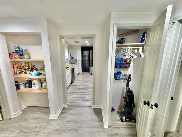 11837 13th St, Santa Fe, TX 77510 - corridor featuring light wood-type flooring, baseboards, and a textured wall
