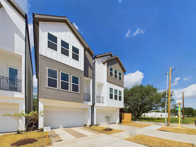 6834 Lozier St, Houston, TX 77021 - view of front facade with board and batten siding, an attached garage, and driveway