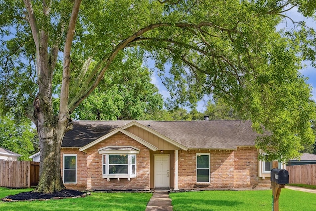 13603 Woodchester Dr, Sugar Land, TX 77498 - ranch-style home featuring a shingled roof, brick siding, and board and batten siding