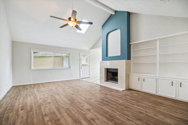 13603 Woodchester Dr, Sugar Land, TX 77498 - unfurnished living room with wood finished floors, ceiling fan, and a high end fireplace