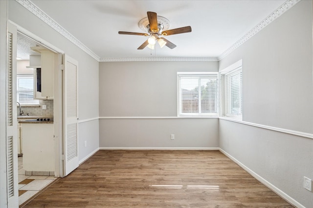 13603 Woodchester Dr, Sugar Land, TX 77498 - unfurnished bedroom featuring light wood-style flooring, crown molding, and ceiling fan