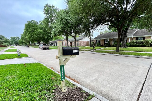 13603 Woodchester Dr, Sugar Land, TX 77498 - view of concrete road with sidewalks and curbs